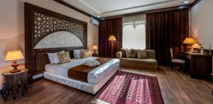 撒马尔罕东方之星酒店的一间带大床的卧室和一间客厅
