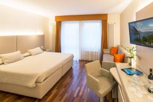 比索内坎皮奥内酒店的一间卧室配有一张床、一张桌子和一张沙发