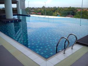 太平Taiping Centre Point Suite的大楼内一个蓝色瓷砖游泳池