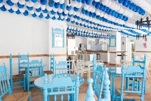 马拉加艾利斯欧斯酒店的一间设有蓝色椅子和蓝色及白色天花板的客房