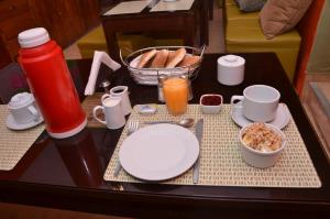 库斯科麦奎旅馆的餐桌上摆放着盘子和碗子的早餐食品