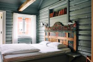 桑德沃伦Kleivstua Hotel near Krokskogen的一间卧室配有一张木墙床