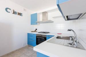 圣维托诺曼Casa Sardelli的厨房配有蓝色橱柜和水槽