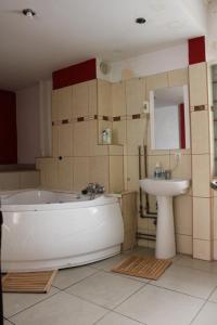 布加勒斯特仙境旅馆的浴室配有白色浴缸和水槽