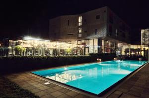 朗根洛伊斯LOISIUM Wine & Spa Hotel Langenlois的一座游泳池,在晚上在建筑物前