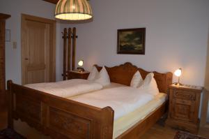 大格迈因“卡塞卡尔”公寓的一间卧室配有一张大木床和白色床单