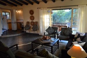 玛洛斯帕克Kruger River Villas - Mtombo的客厅配有沙发和桌子。