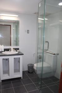 仰光缅甸生活酒店的一间带玻璃淋浴和水槽的浴室