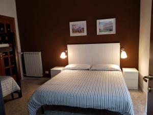 钱皮诺罗马钱皮诺甜蜜生活旅馆的卧室配有一张带两个灯的大白色床