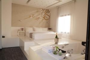 朱拜勒艾礼富精品酒店的白色卧室设有床铺和水槽