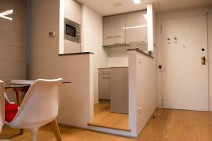 米兰Milano Repubblica Suite Centro的配有桌椅和厨房的房间