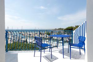 耶尔瑞珍酒店的阳台上配有两把椅子和一张桌子,享有海港的景色
