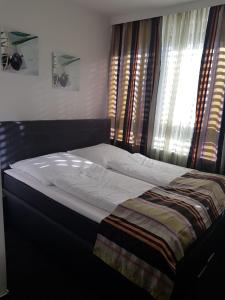 汉堡汉堡湾兹贝克酒店的卧室内的一张床铺,带窗户