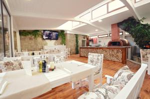 卡赞勒克帕拉斯酒店的一间配备有白色桌椅的用餐室