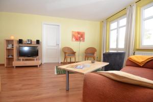 奥斯赛拜-塞林Villa Seerose - Appartement 06的客厅配有桌子和电视