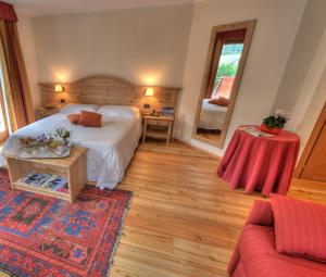 库马约尔克莱斯特艾特杜克酒店的一间卧室配有一张床、一张桌子和一张沙发