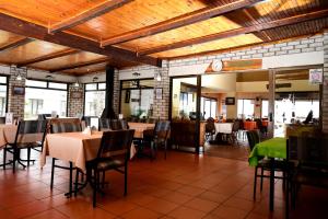 韦尔德里夫Riviera Hotel & Chalets的餐厅内带桌椅的用餐室