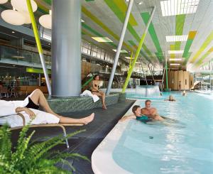 布尔格施普雷瓦尔德T温泉酒店 - 施普利瓦尔德温泉酒店有限公司的一群人躺在游泳池里