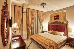 瓦拉日丁Arbia Dorka Heritage Palace的一间卧室配有一张大床和镜子