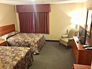 哈利法克斯达特茅斯海岸酒店的酒店客房 - 带两张床、一张桌子和一把椅子