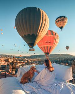 格雷梅密特拉卡弗酒店的女人和狗躺在带热气球的床上