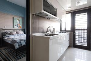 新店LiveGRACE Apartment Xindian的一个带水槽和床的小厨房