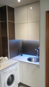 罗萨里奥港海滩附近2V豪华公寓 的厨房配有水槽和洗衣机