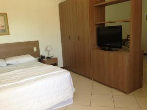 马卡埃水晶酒店的一间卧室配有一张床和一台平面电视