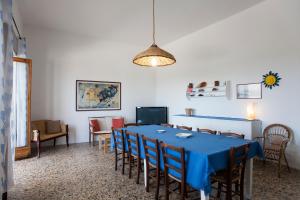 新福卡Villa Mare di Puglia m552的一间配备有蓝色桌子和椅子的用餐室