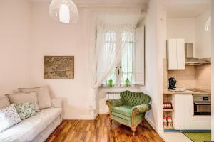 罗马Casa di Nonno Turi的带沙发和绿色椅子的客厅