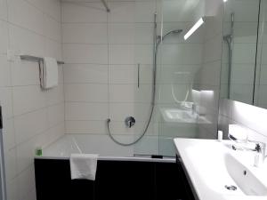 因特拉肯Apartment Silberdistel - GriwaRent AG的带淋浴、浴缸和盥洗盆的浴室