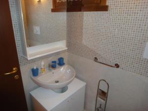帕苏德尔托纳莱SCI AI PIEDI,PASSEGGIATE,MOUNTAIN BIKE,RELAX的浴室设有白色水槽和镜子