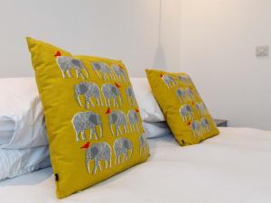 伯恩茅斯Dale House - Vivre Retreats的床上的2个黄色枕头