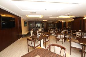 亚喀巴阿尔齐露娜酒店的用餐室配有木桌和椅子