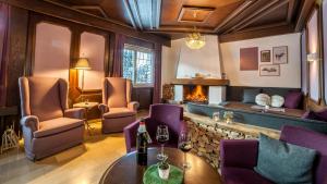 蒂罗尔-泽费尔德Boutique Hotel Olympia的一间带壁炉和桌椅的餐厅
