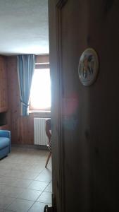 圣卡特琳娜瓦尔夫贝图尔小屋酒店的客厅设有窗户和蓝色沙发