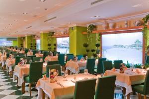 卡内拉岛Playamarina的用餐室配有桌子和绿色椅子