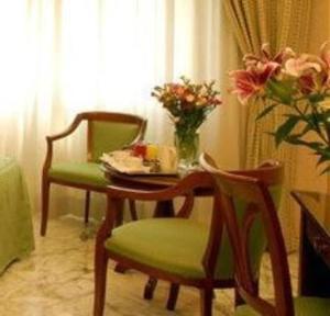 罗马桑皮耶特罗酒店的一张桌子和两把椅子,上面有花瓶