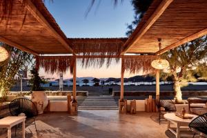 迈洛波塔斯狄俄尼索斯海滨度假酒店的一个带桌椅的海景庭院