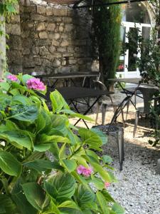 贝尔格新城德拉曼斯酒庄酒店的庭院设有桌子、长椅和鲜花
