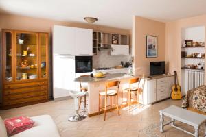 阿罗纳La Casa di Cristina的一间厨房,配有白色橱柜和厨房岛