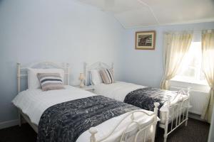 马林Barney's Lodge的一间卧室设有两张床和窗户。