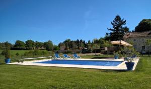 MontembœufLa Bucherie的庭院内的游泳池配有椅子和遮阳伞