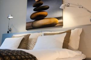 斯德哥尔摩比列雅居酒店的一间卧室配有带枕头的床铺和绘画