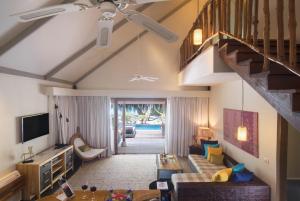 北马累环礁Taj Coral Reef Resort & Spa - Premium All Inclusive with Free Transfers的带沙发和楼梯的客厅