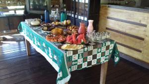 圣罗克迪米纳斯Pousada Estância Macaúbas -的一张桌子,上面有餐桌布,上面有食物