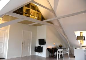 奥斯特豪特Zzzuite25的客厅设有横梁天花板和桌椅