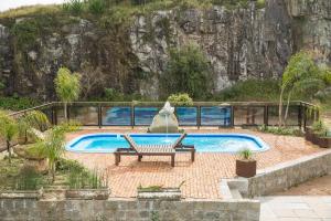 CristalPousada Pedra Bonita的游泳池旁设有长凳