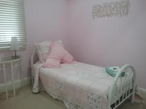 库纳巴拉布兰兰利小屋住宿加早餐旅馆的一张小床,上面有粉红色枕头