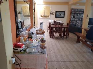 卡纳内亚Pousada Recanto do Morro的厨房以及带餐桌和食物的用餐室。